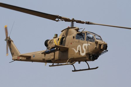 An AH-1S Tzefa helicopter in flight by Ofer Zidon/Stocktrek Images art print