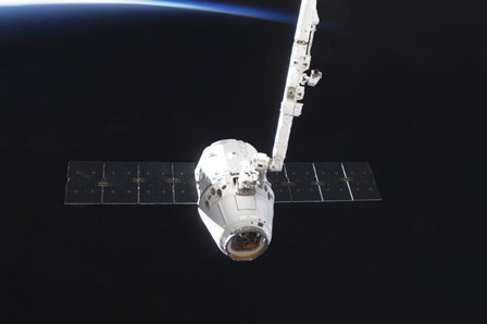 The SpaceX Dragon Cargo Craft Prior to Being Released from the Canadarm2 by Stocktrek Images art print